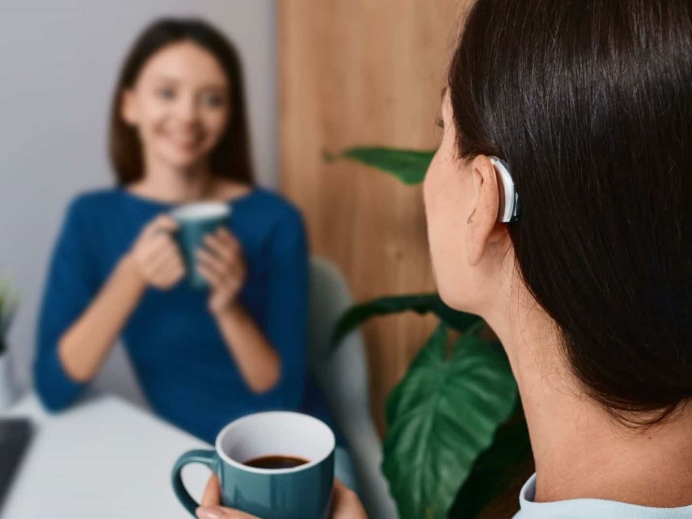 Woman wearing a receiver-in-canal hearing aid, one of several styles fitted at Brighter Hearing in Savannah, GA