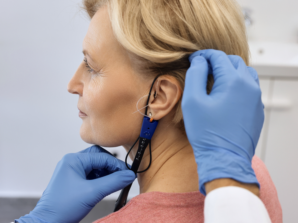 Doctor of Audiology performing real ear measurement on a hearing aid patient at Brighter Hearing in Savannah, GA